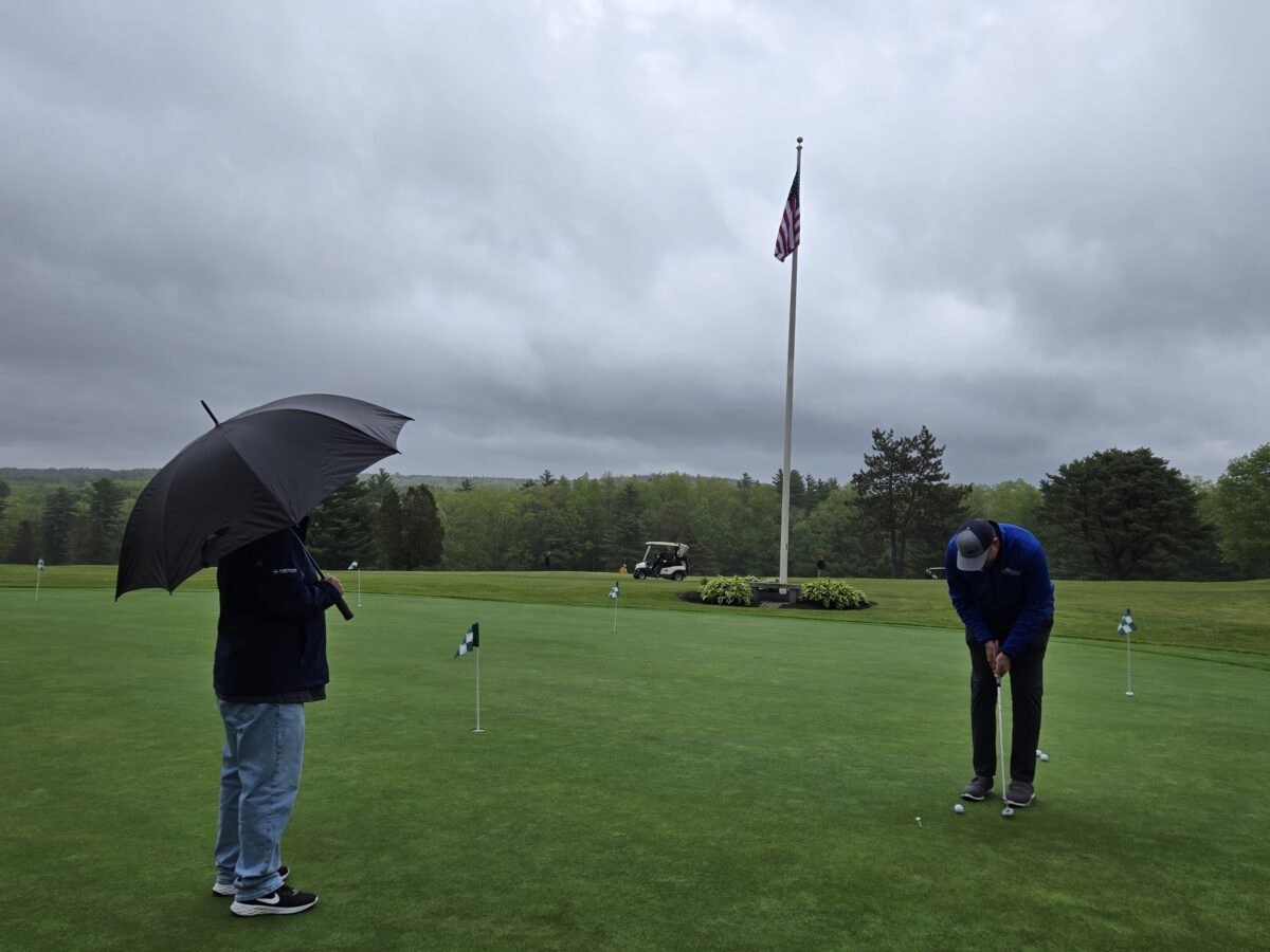 golfers in the rain